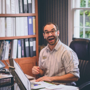 a man works happily in his home office after installing soundproofing windows