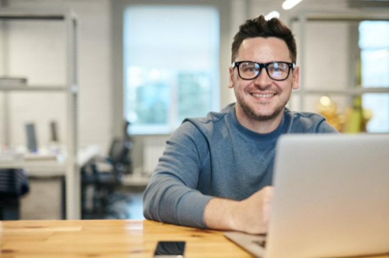 a man works happily in his home office after installing soundproofing windows