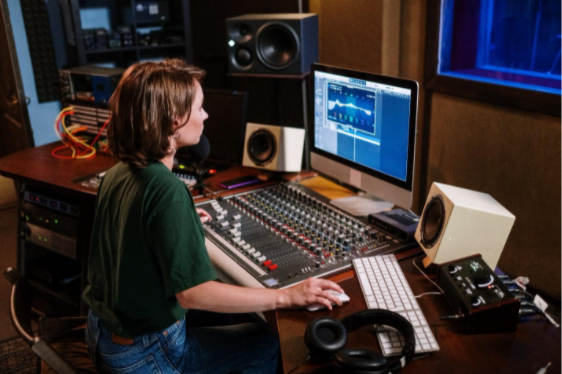 a woman playing audio mixer after soundproofing her windows