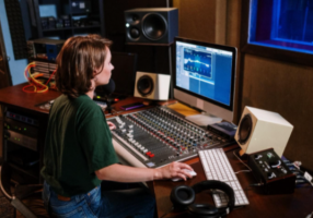 a woman playing audio mixer after soundproofing her windows